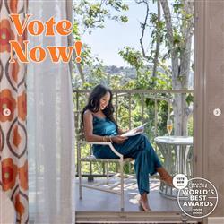 woman reading a magazine on a balcony