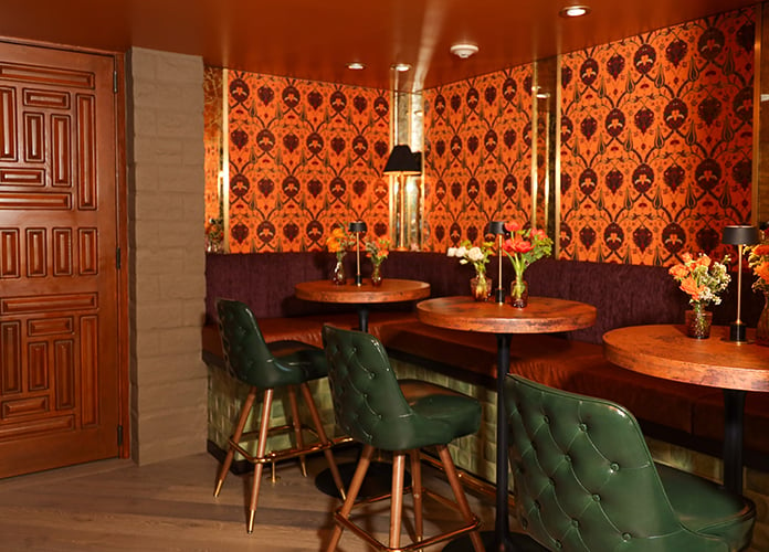 The Tangerine Room cocktail tables and booth seating